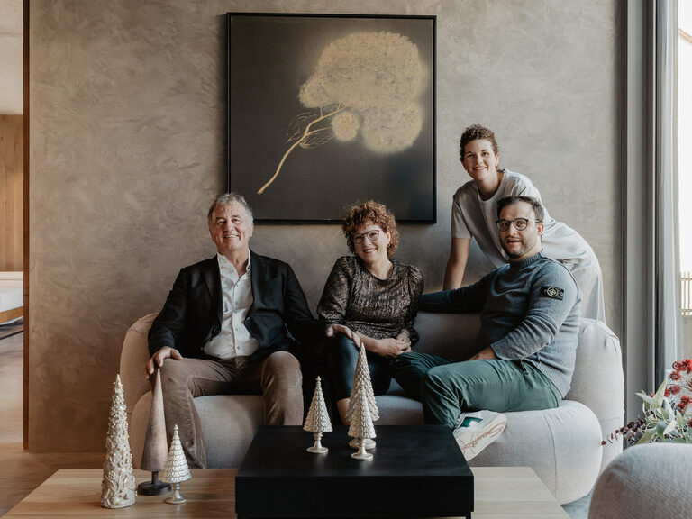 Der Gastgeber Familie genießt Komfort auf einem grauen Sofa im stilvollen Raum.
